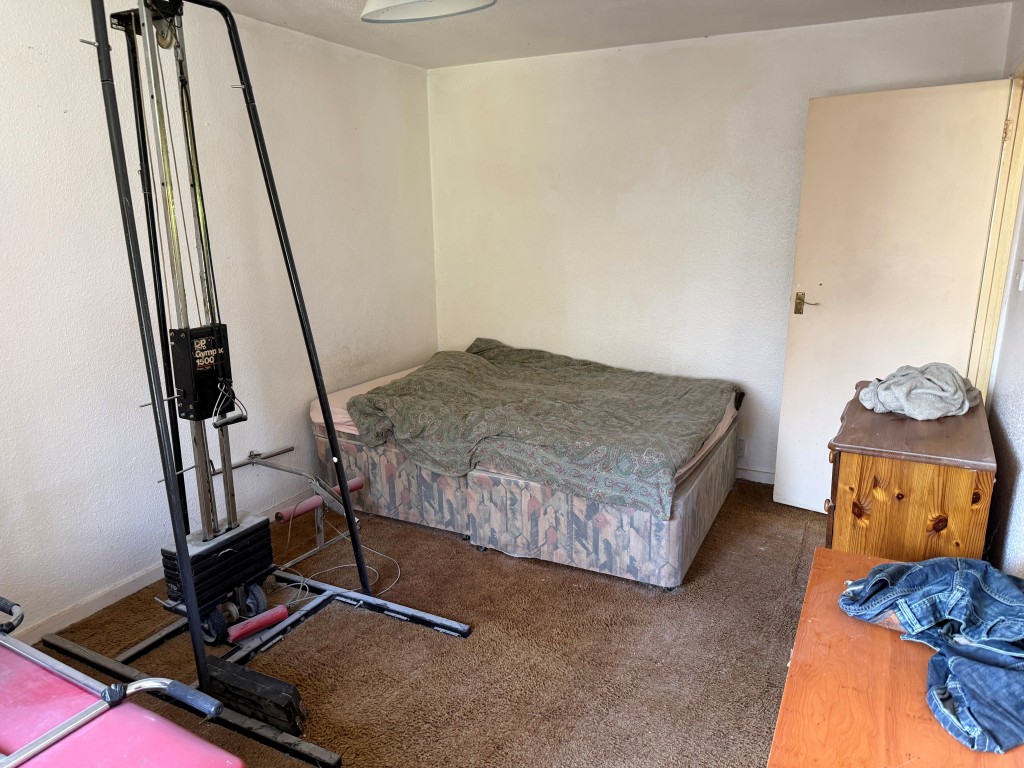 Lot: 134 - TWO-BEDROOM FLAT WITH GARAGE IN NEED OF UPDATING - Rear of main bedroom with bed area